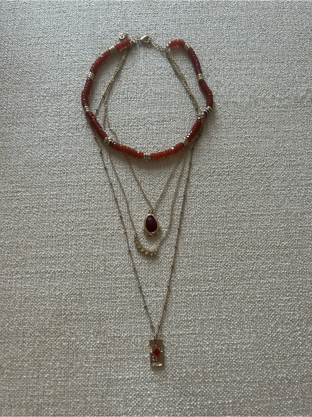 Quadruple Layered Gold Necklace with Carnelian Colored Beads and Pendants